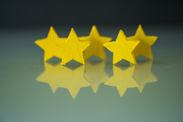 Yellow wooden five star shape. The best excellent business services rating customer experience concept