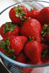 fresh strawberries in a bowl with water, upper view