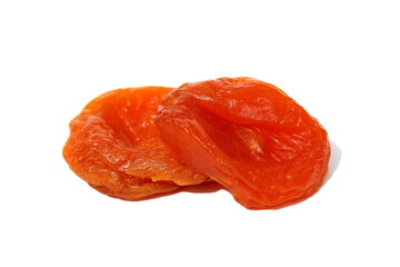 Two pieces of dried apricots lie on a white isolated background.