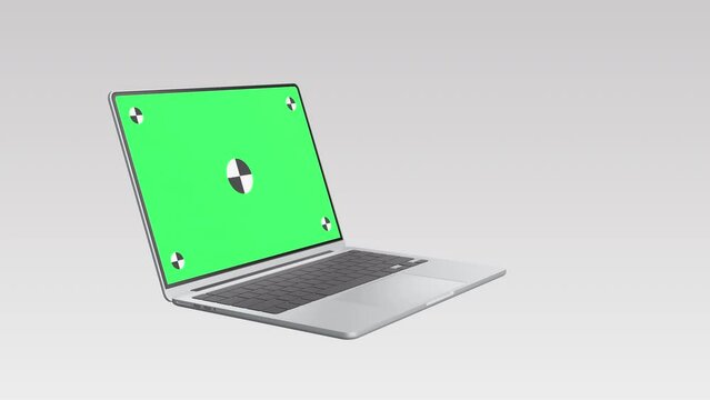 Realistic thin laptop computer 3d animation. Highly detailed metallic notebook open cover with green screen on white background. Zoom in display with mark spot ready to track your own photo or video.