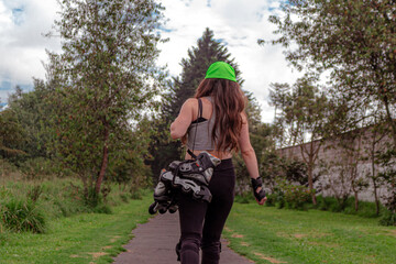 young sporty woman walking with line skates, ready to practice skating.