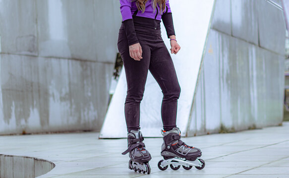young sporty woman practicing inline skating in an urban setting