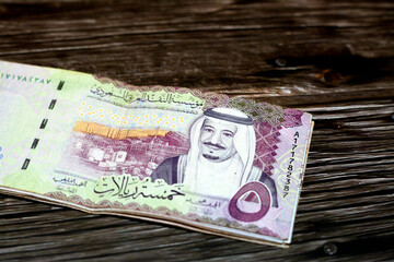Stack of Saudi Arabia 5 SAR five Saudi riyals cash money banknote with the photo of king Salman Bin...