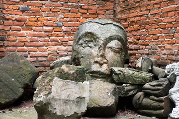 Ancient broken damage buddha statue in antique ruins ubosot for thai people travelers travel visit...