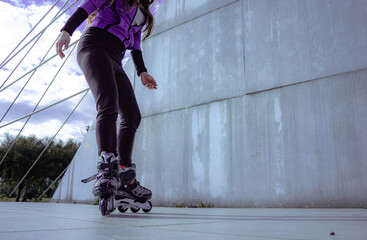 young sporty woman practicing inline skating in an urban setting