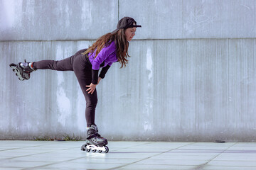 young sporty woman practicing inline skating in an urban setting