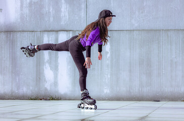 young sporty woman practicing inline skating in an urban setting