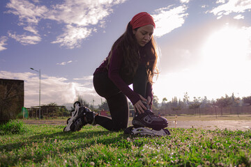 young sporty woman practicing inline skating in an urban setting. Preparing herself to skate.