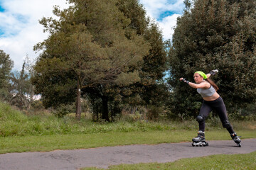young sporty woman practicing inline skating in an urban setting