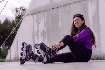 young sporty woman practicing inline skating in an urban setting