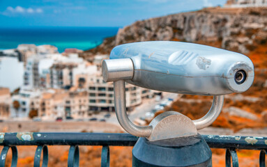 Telescope with a city view from a high vantage point