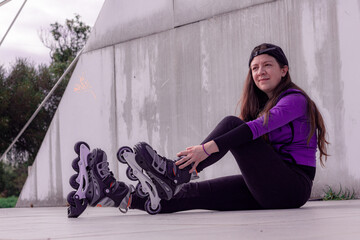 young sporty woman practicing inline skating in an urban setting