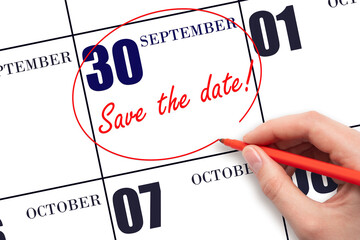 Hand drawing red line and writing the text Save the date on calendar date September 30.