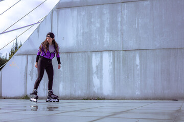 young sporty woman practicing inline skating in an urban setting