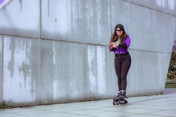 young sporty woman practicing inline skating in an urban setting