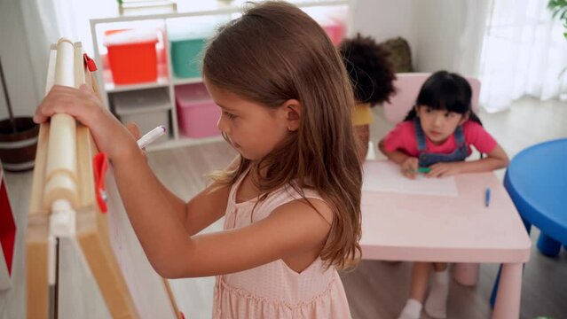 Preschool teacher with children study in classroom. Kindergarten back to school a