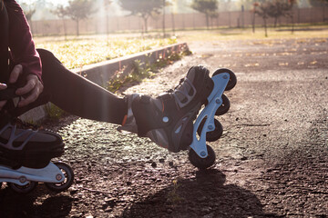 young sporty woman practicing inline skating in an urban setting. Preparing herself to skate.