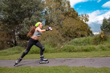 young sporty woman practicing inline skating in an urban setting. High quality photo