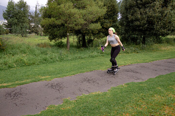 young sporty woman practicing inline skating in an urban setting. High quality photo
