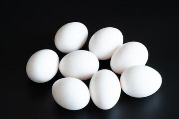 white eggs on black background
