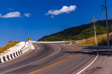 The curve of the road that sloping down the mountain