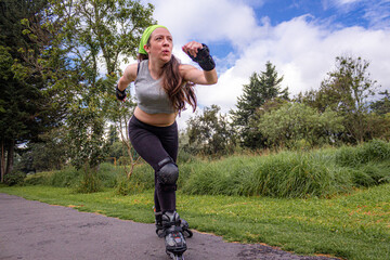 young sporty woman practicing inline skating in an urban setting. High quality photo