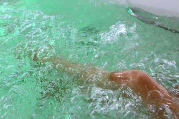 spa treatments for graceful feet in the bath with bubbles and colored lights