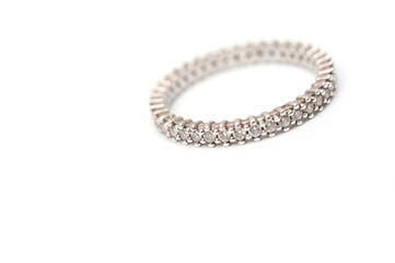 Silver color ring with decorative stones on a white background.