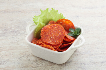 Sliced pepperoni sausage in the bowl
