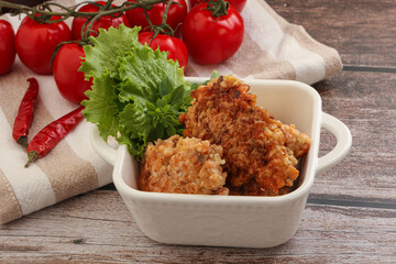 Fried salmonn cutlet in the bowl