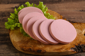Sliced sausage snak over board © Andrei Starostin