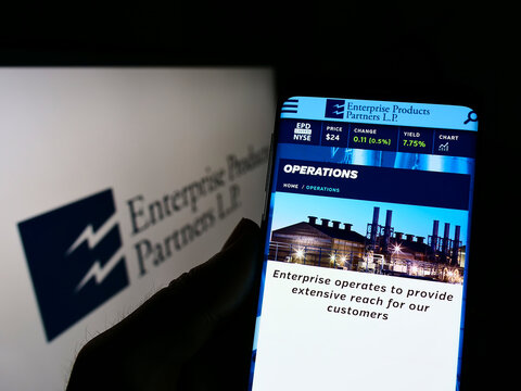 Stuttgart, Germany - 02-05-2022: Person holding cellphone with webpage of pipeline company Enterprise Products Partners L.P. on screen with logo. Focus on center of phone display.
