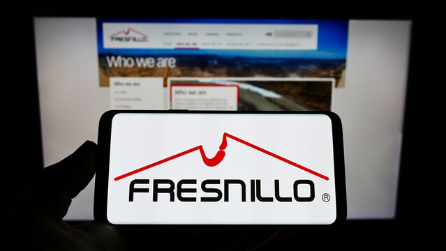 Stuttgart, Germany - 02-05-2022: Person holding smartphone with logo of metals mining company Fresnillo plc on screen in front of website. Focus on phone display.