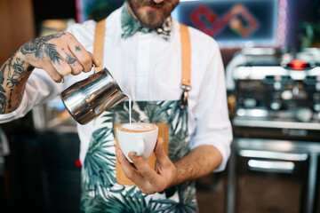 Close up of skilled cafeteria worker making coffee.
