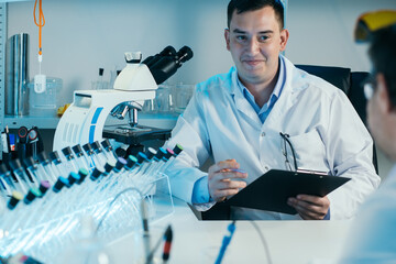 Scientist working with microscope in lab. Laboratory research concept.