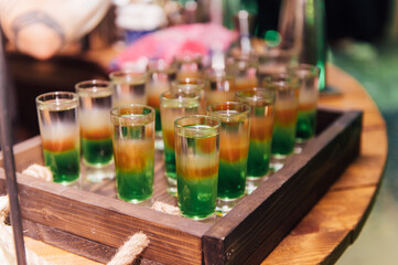 Glasses with different cocktails. Long and short cocktails at a party with disco lighting