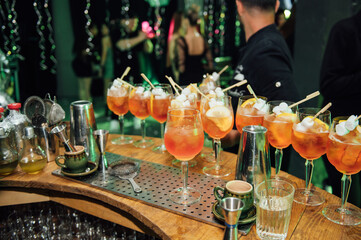 Glasses with different cocktails. Long and short cocktails at a party with disco lighting