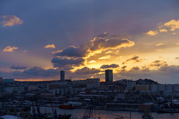A cityscape at dawn with the rays of the sun. Vladivostok, Russia