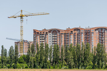 Construction crane. Construction of a residential complex. Modern architecture. Real estate market....