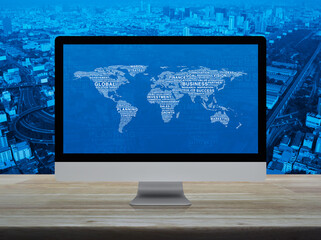 Global business words world map on computer screen on table over city tower, street, expressway and skyscraper, Global business online concept, Elements of this image furnished by NASA