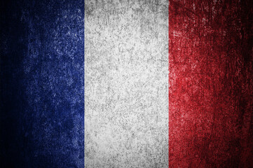 Closeup of grunge French flag. Dirty France flag on a metal surface