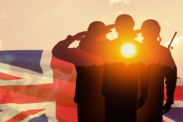 Silhouettes of soldiers with print of sunset saluting on a background of United Kingdom flag.