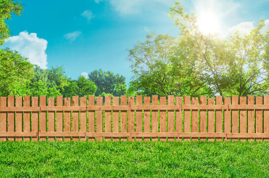 wooden garden fence at backyard and lawn with grass in park