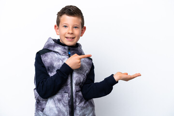 Little boy isolated on white background holding copyspace imaginary on the palm to insert an ad