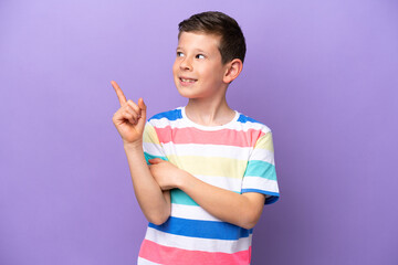 Little boy isolated on purple background pointing up a great idea
