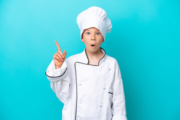 Little chef boy isolated on blue background intending to realizes the solution while lifting a finger up