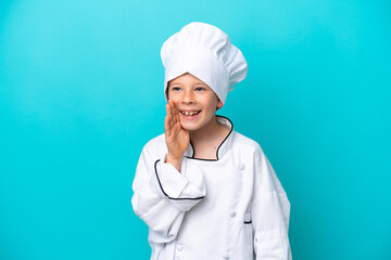 Little chef boy isolated on blue background shouting with mouth wide open to the side