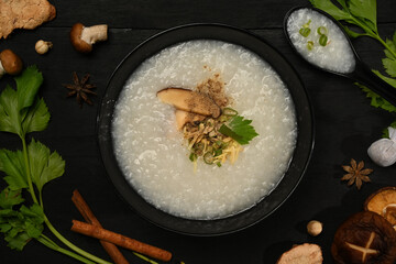 Traditional Chinese rice porridge with soft boiled egg, slice ginger and slice scallion topping for breakfast or light meal