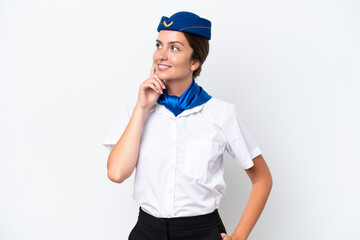 Airplane stewardess caucasian woman isolated on white background thinking an idea while looking up