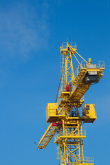 Yellow crane on the blue sky background